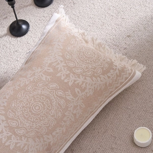Bohemian mandala jacquard pillow cover with tassels on a cozy beige textured rug