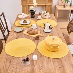 Set of 4 bright yellow round woven PP placemats for heat-resistant dining table decor