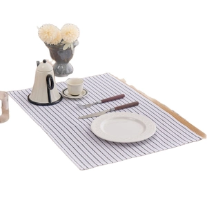Minimalist brown striped rectangle table mat with white porcelain tableware and cutlery