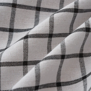Close-up of black and white gingham fabric showing natural cotton linen texture and soft drapes