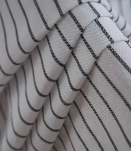 Detail of minimalist white and black thin striped fabric with a soft linen texture