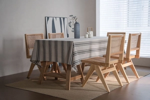 Close-up of minimalist linen texture tablecloth with grey stripes on a wooden dining table