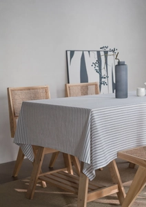 Close-up of minimalist black and white striped cotton linen tablecloth on wooden table