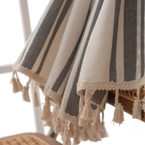 Striped grey and beige linen fabric curtain with decorative tassel fringe detail