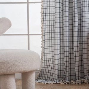 Modern black and white plaid curtains with elegant tassel trim and cotton-linen texture