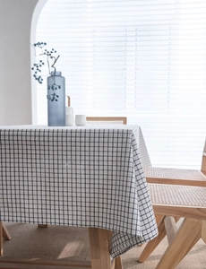 Close-up of black and white gingham tablecloth texture with soft natural window lighting