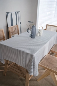 Detailed view of striped linen tablecloth with vertical black and white minimalist patterns