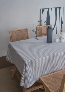 Detail view of black and white plaid cotton linen tablecloth with elegant draped edges