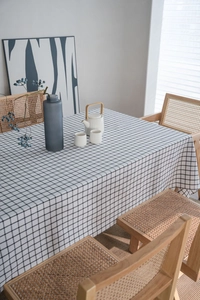 Detailed close-up of checkered cotton linen tablecloth with elegant black grid pattern