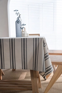 Detail of minimalist yarn-dyed striped tablecloth with elegant cotton linen texture