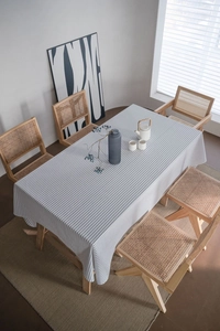 Detail of minimalist black and white striped cotton linen tablecloth on a rectangle table