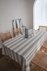 Detailed macro view of gray and white striped cotton linen tablecloth with natural draping