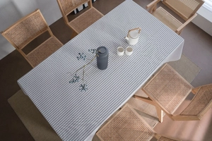 Close-up of minimalist grey and white striped linen tablecloth on a dining table