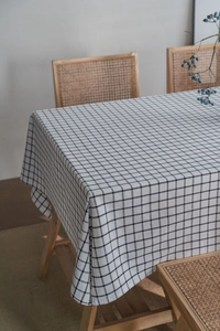 Detail showing high-quality black and white grid linen tablecloth texture and fabric drape