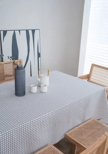 Detailed top view of black and white checkered linen tablecloth in a Nordic home setting