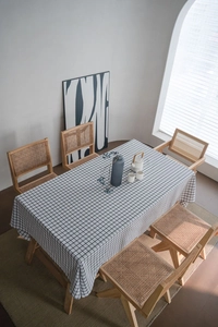 Minimalist black and white plaid cotton linen tablecloth on a large wooden dining table