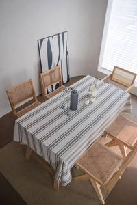 Close-up of minimalist striped linen tablecloth on a modern rectangular dining table