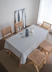 Detail of minimalist black and white checkered cotton linen tablecloth on a dining table