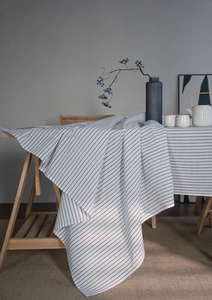Detail showing high-quality cotton linen tablecloth with minimalist black stripes and texture