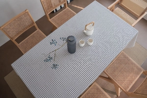 Macro shot of minimalist black and white checkered cotton linen tablecloth on dining table