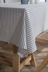 Close-up of minimalist black striped linen tablecloth showing fabric texture and drape