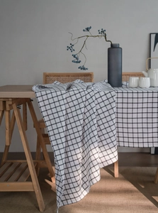 Close-up of black and white checkered linen tablecloth showing texture and drape