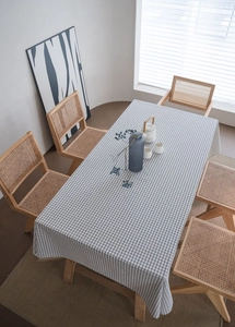 Top view of black and white checkered cotton linen tablecloth on a rectangle dining table