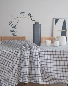 Close-up of black and white grid linen tablecloth with natural texture and drape