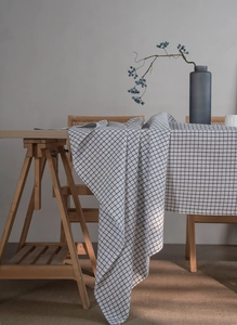 Detailed texture of black and white grid linen tablecloth in a Nordic style setting
