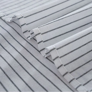Gray striped linen cotton tablecloth with neat hemmed edges in a minimalist design