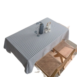 Classic black and white checkered linen tablecloth shown on a rectangular dining table