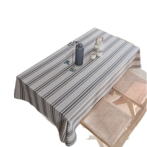 Modern minimalist beige and grey striped tablecloth with cotton-linen texture on dining table