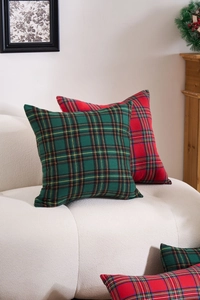 Classic red and green plaid holiday pillow covers displayed on a sofa for festive decor
