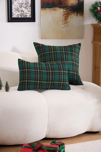 Detail of green plaid festive cushion set with woven texture on white sherpa sofa