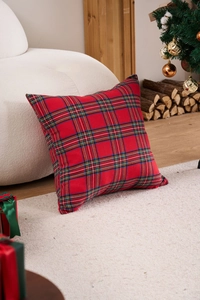 Close-up of red tartan plaid pillow cover in a cozy Christmas living room setting