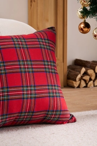 Close-up of red plaid Christmas pillowcase featuring classic Scottish tartan pattern