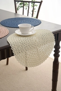Detailed macro view of hand-woven lace round placemats with delicate hollow textures
