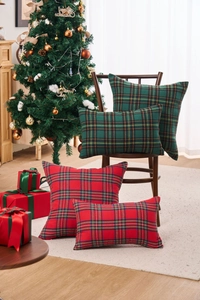 Close-up of festive red and green plaid cushion covers in a cozy Christmas scene