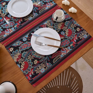 Detailaufnahme von Jacquard-Tischsets mit Paisley-Blumenmuster auf Holztisch