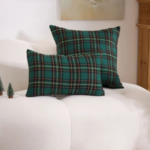 Green tartan plaid cushion covers set on sofa for cozy Christmas home decoration