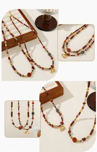 Detailed shot of golden elephant pendant and Bohemian multi-colored stone beaded necklace