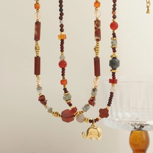 Bohemian natural red agate stone beaded necklace with a polished gold elephant pendant