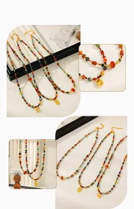 Detail of bohemian beaded necklace with golden elephant pendant and colorful stones