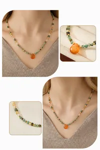 Detail of bohemian necklace with orange teardrop pendant and multi-color beads