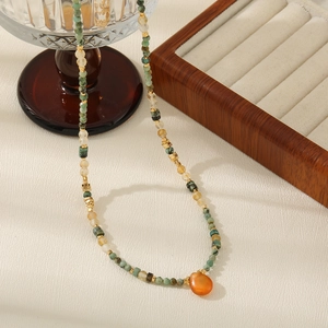 Elegant beaded necklace with African turquoise, white beads and orange teardrop pendant
