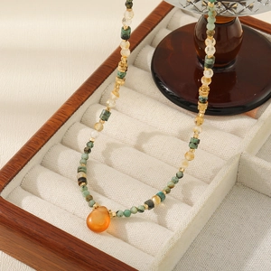 Vintage African turquoise beaded necklace with a polished orange teardrop pendant