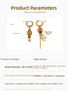 Detailed view of asymmetric earrings with tiger eye stone and bird pendant on brass base