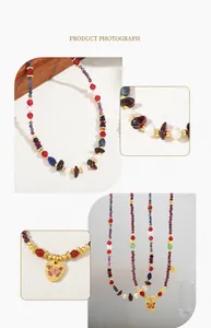 Detailed close-up of a vintage beaded necklace with red agate, pearls, and butterfly pendant