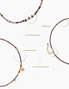 Detail of garnet necklace with freshwater pearl beads and vintage butterfly charm