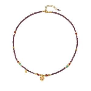 Vintage garnet beaded necklace with gold butterfly pendant and Fu charm on white background
